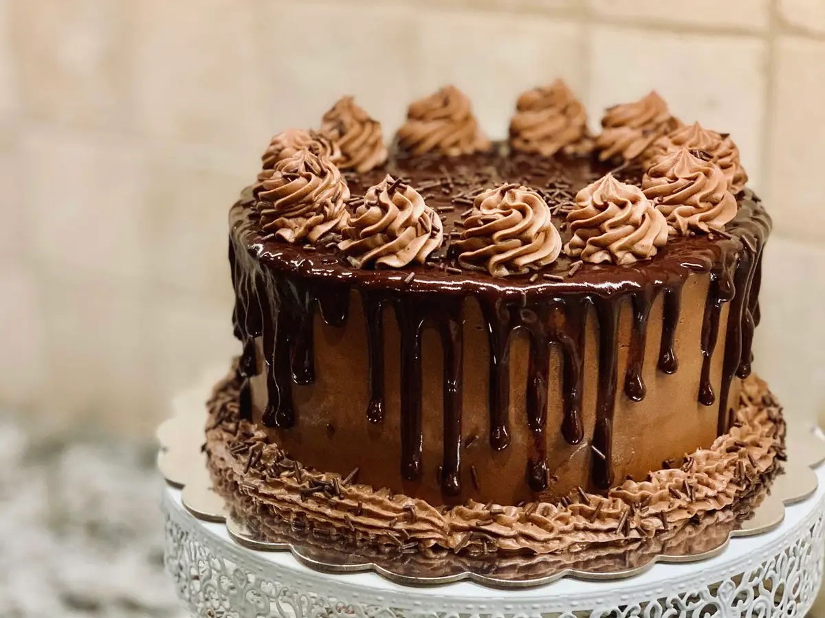 A chocolate layer cake on a stand