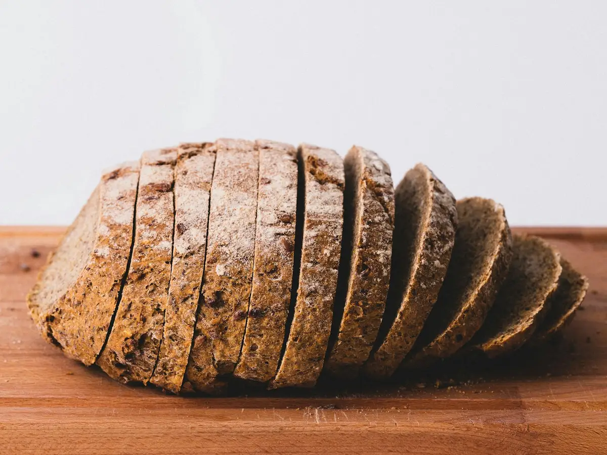 A fresh loaf, sliced on a wooden board